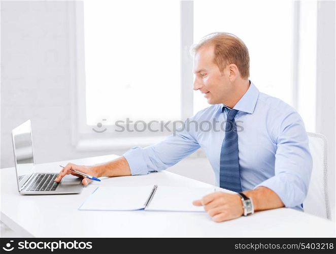 business, office, school and education concept - smiling businessman working in office