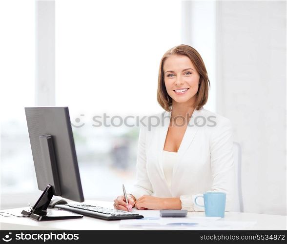 business, office, school and education concept - smiling businesswoman with computer, documents and coffee