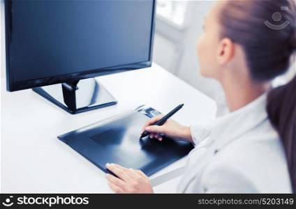 business, office, school and education concept - smiling businesswoman with drawing tablet in office. businesswoman with drawing tablet in office