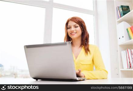 business, office, school and education concept - smiling businesswoman with laptop computer in office