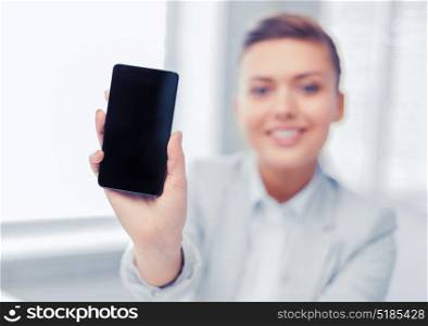 business, office, school and education concept - smiling businesswoman with smartphone in office. businesswoman with smartphone in office