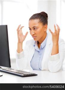 business, office, school and education concept - stressed african businesswoman with computer at work