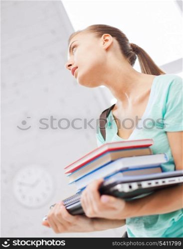 business, office, school and education concept - student with books, computer and folders