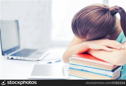 business, office, school and education concept - tired student sleeping on stock of books. tired student sleeping on stock of books