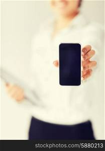 business, office, school and education concept - woman hand with smartphone