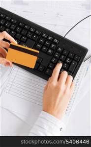 business, office, shopping and money concept - businesswoman with computer using credit card