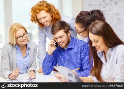 business, office, technology and startup concept - creative team with papers and clipboard working at office