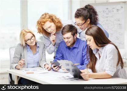 business, office, technology and startup concept - creative team with papers and clipboard working at office