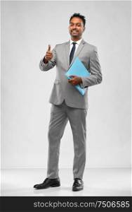 business, office worker and people concept - smiling indian businessman in shirt with tie showing thumbs up over grey background. indian businessman showing thumbs up