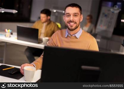 business, overwork and people concept - happy male office worker drinking coffee. happy male office worker drinking coffee. happy male office worker drinking coffee