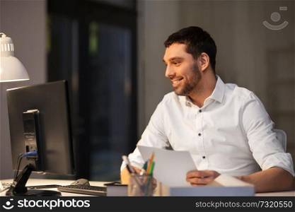 business, overwork, deadline and people concept - businessman with computer and papers working at night office. businessman with computer working at night office