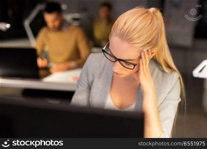 business, overwork, deadline and people concept - tired businesswoman in glasses working at night office. tired businesswoman working at night office. tired businesswoman working at night office