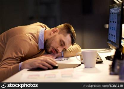 business, overwork, deadline and people concept - tired man sleeping on table at night office. tired man sleeping on table at night office