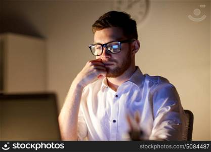 business, overwork, people, deadline and technology concept - businessman in glasses with laptop computer thinking at night office. businessman in glasses with laptop at night office. businessman in glasses with laptop at night office