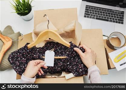 Business owner packing online order to delivery to customer. Preparing parcel box with clothes product from online shop