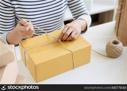 Business owner woman working online shopping prepare product packaging process at her home, young entrepreneur concept