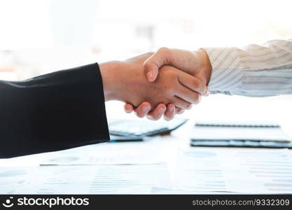 Business partner colleagues shaking hands meeting with new startup project plan Finance and Economy Graph with laptop successful teamwork