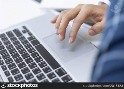 Business partners concept a businessman scrolling on a touch pad of a laptop while checking items list.