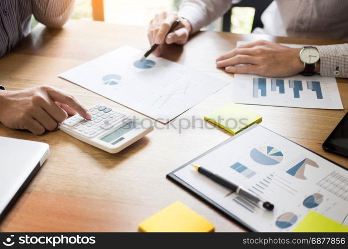 business partners discussing documents and ideas plans to his colleagues at meeting at workspace office.