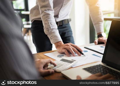 business partners discussing documents and ideas plans to his colleagues at meeting at workspace office.