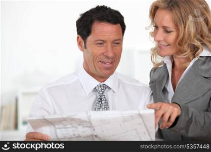 business partners looking at plans