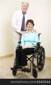 Business partners or married couple - the woman is in a wheelchair.