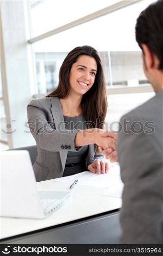 Business partners shaking hands after meeting