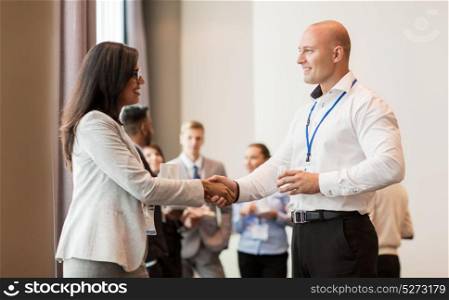 business, partnership and cooperation concept - handshake of people at international business conference. handshake of people at business conference