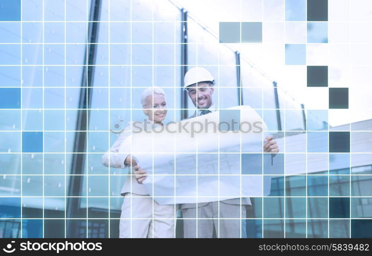 business, partnership, architecture and people concept - smiling businessman and businesswoman with blueprint and helmets over city street and blue grid background