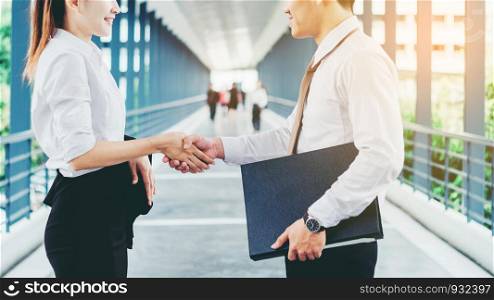 Business partnership handshaking after striking deal outdoors at meeting