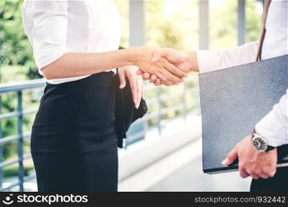 Business partnership handshaking after striking deal outdoors at meeting