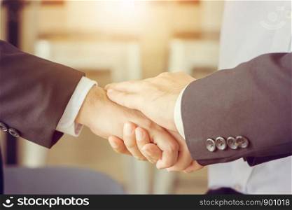 Business partnership meeting concept. Close-up of Successful businessmen handshaking after good deal.