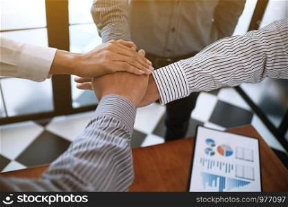 Business partnership putting hands together