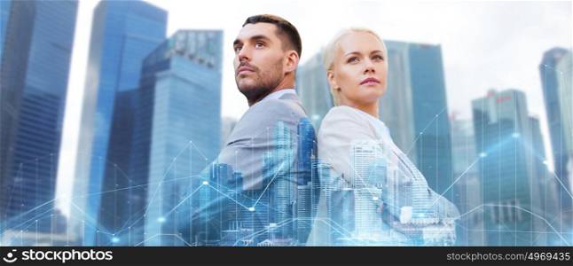 business, partnership, success and people concept - businessman and businesswoman standing over city and office buildings with charts background. businessman and businesswoman in city