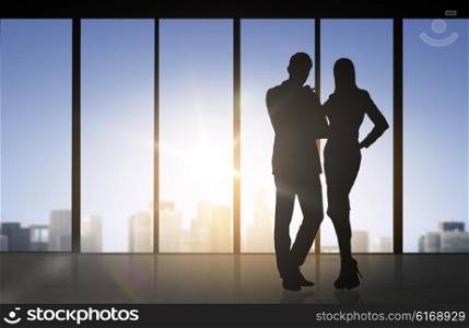 business, partnership, teamwork and people concept - silhouettes of partners over office window background