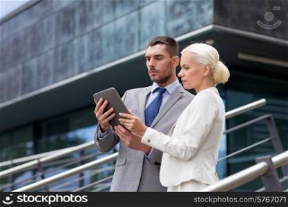 business, partnership, technology and people concept - businessman and businesswoman working with tablet pc computer on city street