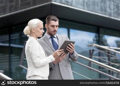 business, partnership, technology and people concept - businessman and businesswoman working with tablet pc computer on city street