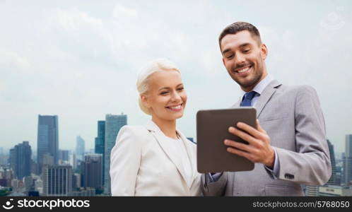 business, partnership, technology and people concept - smiling businessman and businesswoman with tablet pc computer over city background