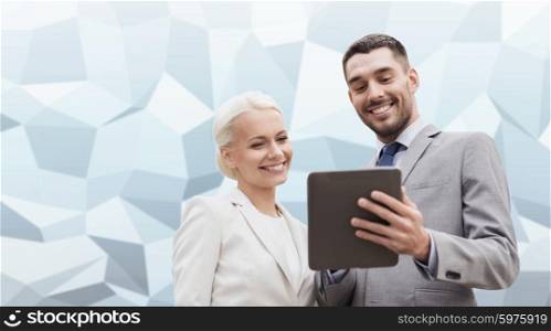 business, partnership, technology and people concept - smiling businessman and businesswoman with tablet pc computer over gray blue graphic low poly background