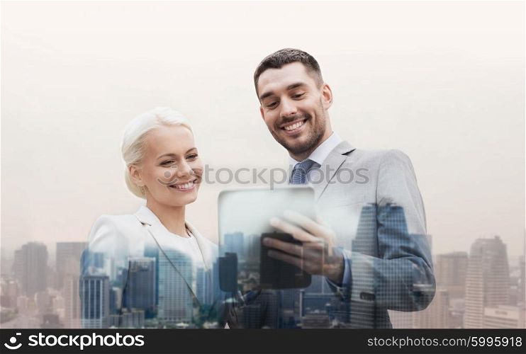 business, partnership, technology and people concept - smiling businessman and businesswoman with tablet pc computer over city background