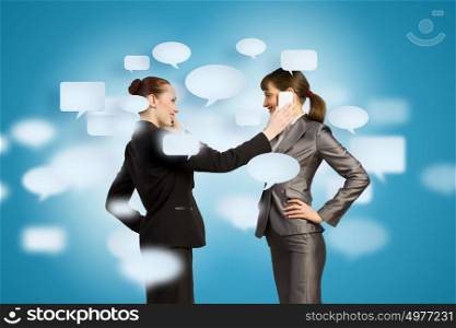 Business partnership. Two businesswomen talking on mobile phone. Cooperation concept