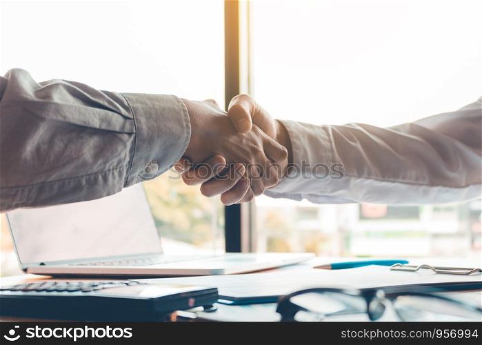 Business people accept or confirm project on the proposal and join shaking hands at office.