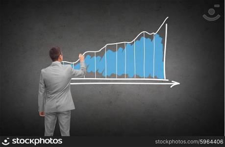 business, people, advertisement , information and office concept - businessman drawing diagram chart from back over dark gray concrete wall background