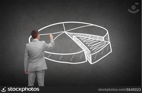 business, people, advertisement , information and office concept - businessman drawing pie chart from back over dark gray concrete wall background