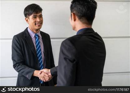 Business people agreement concept. Asian Businessman do handshake with another businessman in the office meeting room.