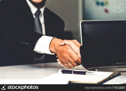 Business people agreement concept. Businessman and Asian businesswoman do handshake in the office.