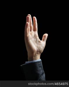 business, people and advertisement concept - close up of raised businessman hand over black background