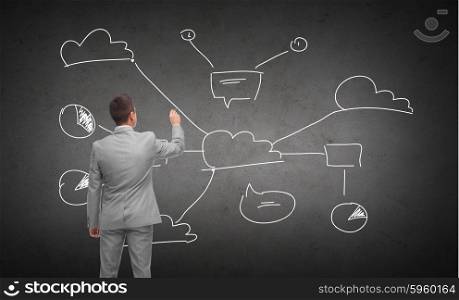 business, people and cloud computing concept - businessman drawing cloud computing scheme over dark gray concrete wall background