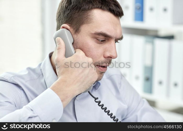 business, people and communication concept - face of angry businessman calling on phone in office