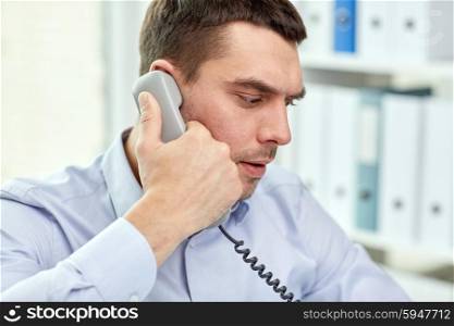 business, people and communication concept - face of angry businessman calling on phone in office